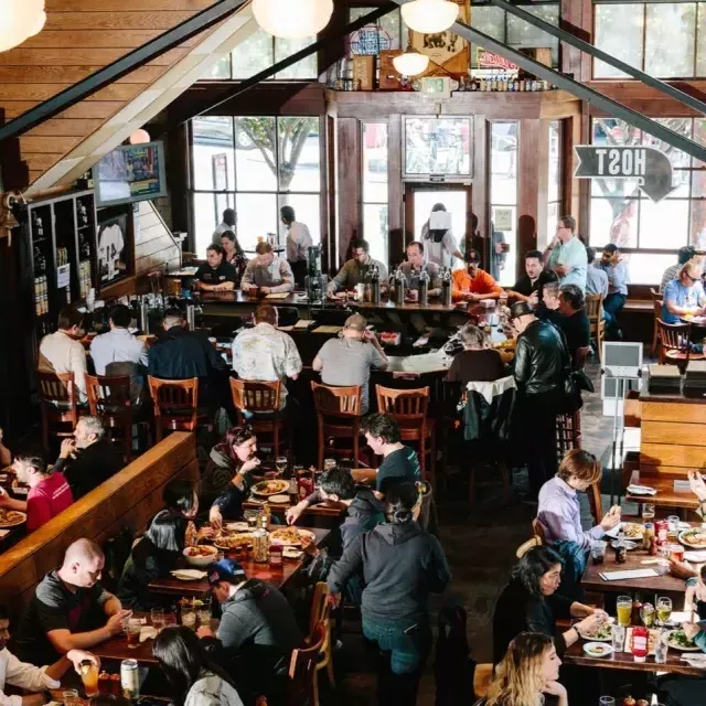 Patrons eat and drink inside the 21st Amendment Brewery in San Francisco.